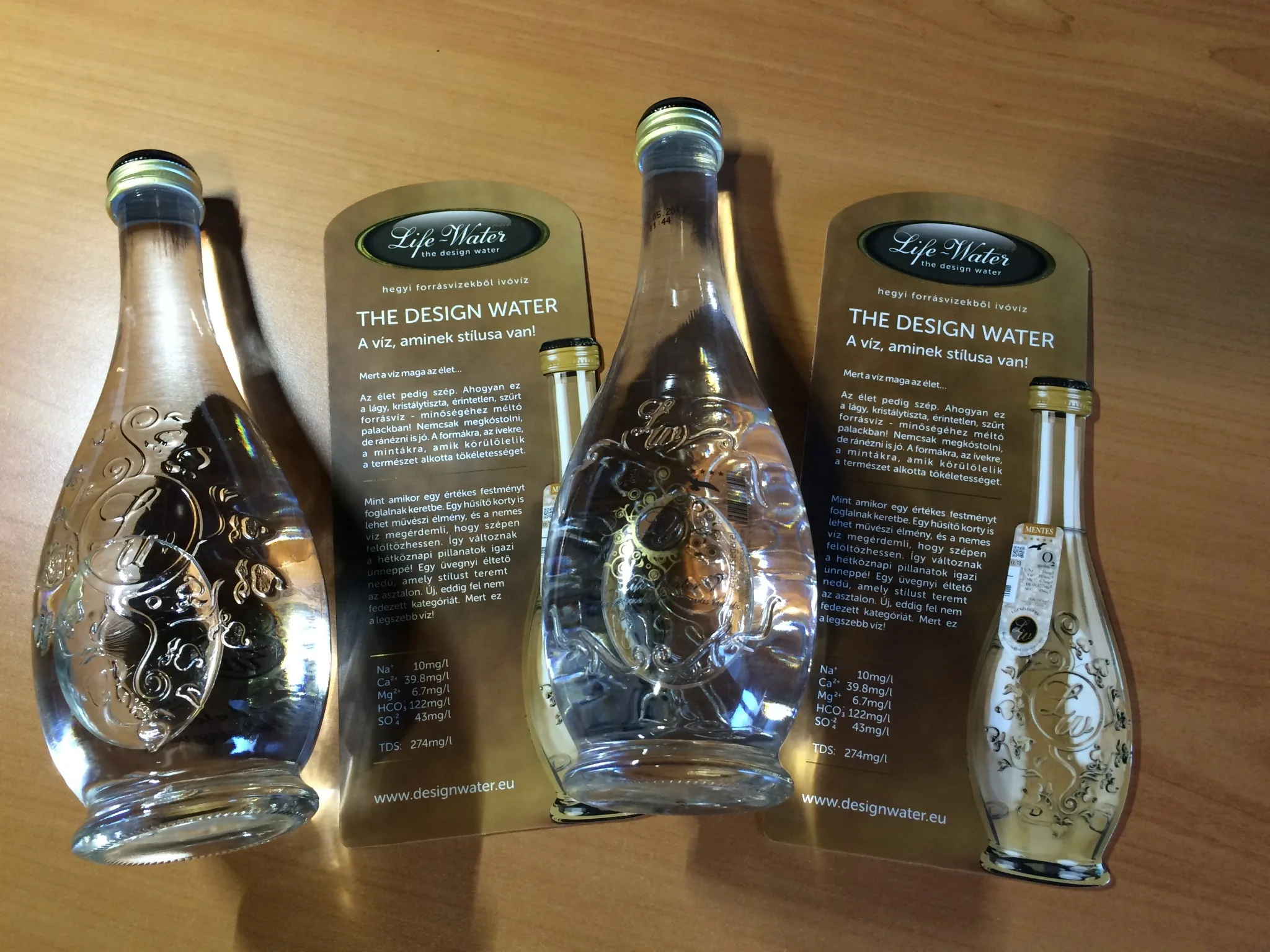 Díszes formájú Life Water palackok aranyszínű Design Water ismertetők mellett